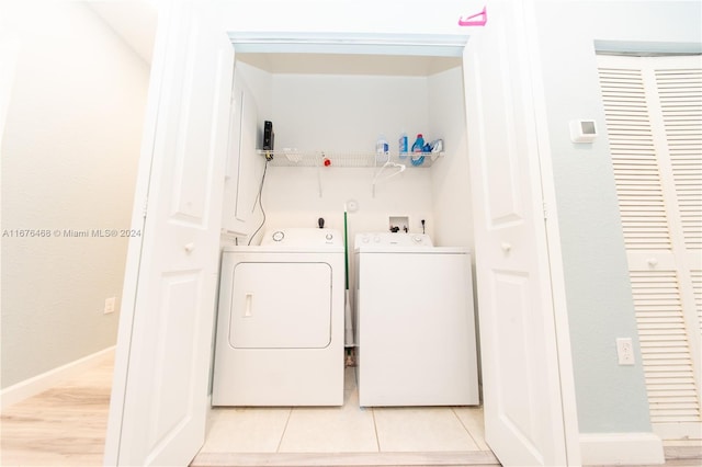 washroom featuring light hardwood / wood-style floors and washer and dryer