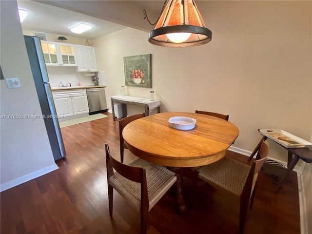 dining space featuring sink and dark hardwood / wood-style flooring