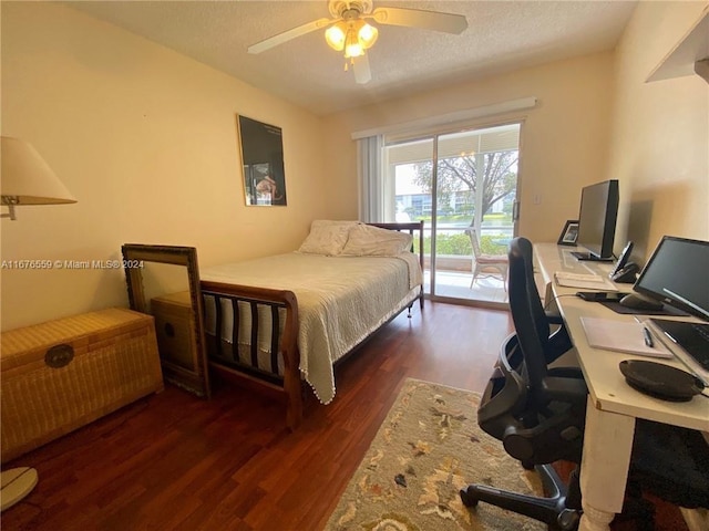 bedroom with a textured ceiling, dark wood-type flooring, and ceiling fan