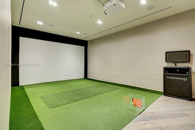 playroom featuring golf simulator and carpet floors