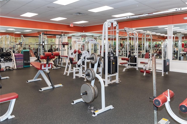 gym with a paneled ceiling