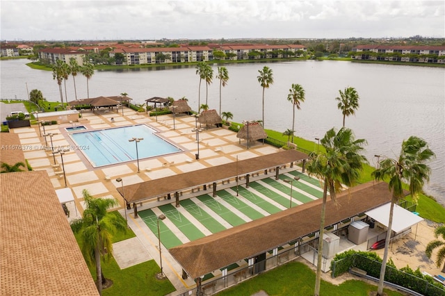 view of swimming pool with a patio and a water view