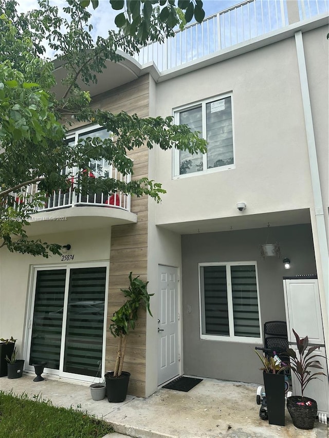 rear view of property with a balcony