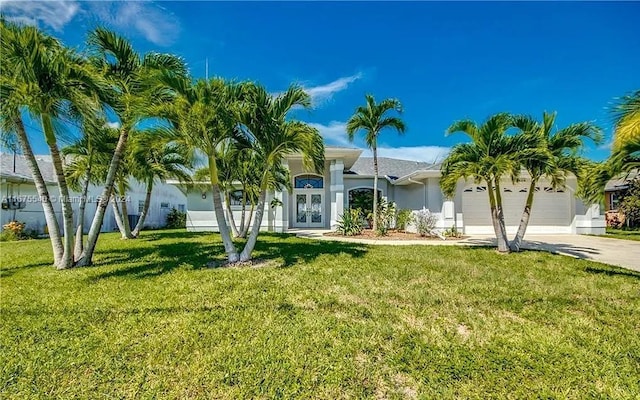 view of front of home featuring a garage and a front lawn