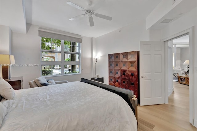 bedroom featuring light hardwood / wood-style floors and ceiling fan