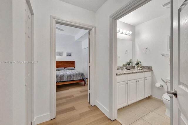 bathroom featuring vanity, hardwood / wood-style floors, and toilet