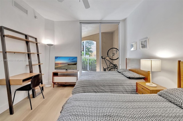 bedroom with lofted ceiling, access to exterior, light hardwood / wood-style floors, and ceiling fan