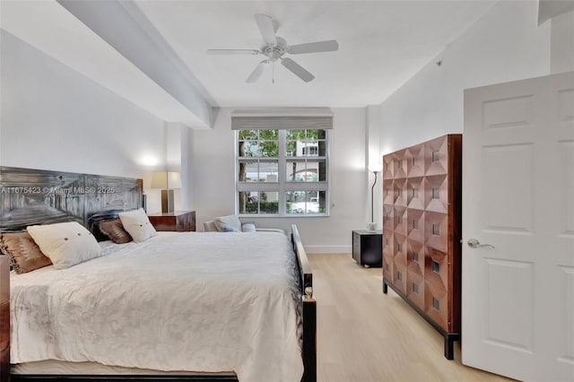 bedroom featuring baseboards, light wood-type flooring, and ceiling fan