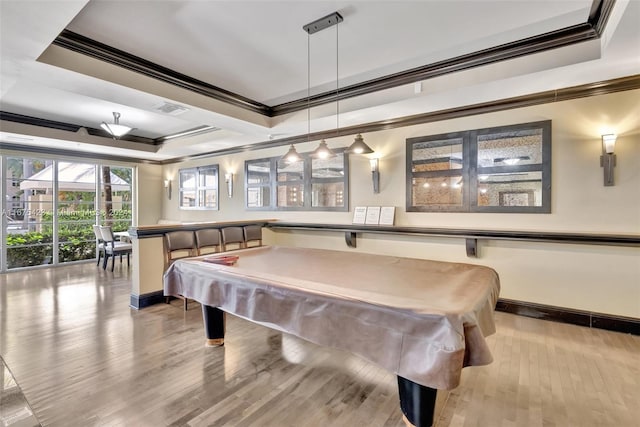 playroom featuring light hardwood / wood-style flooring, ornamental molding, a tray ceiling, and pool table