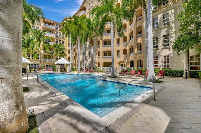 community pool featuring a gazebo and a patio area