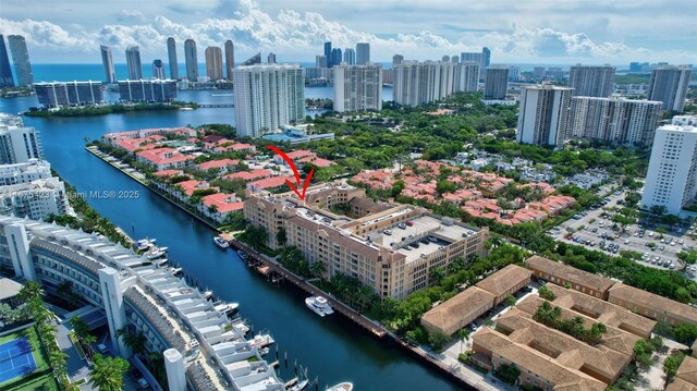 drone / aerial view featuring a water view and a view of city