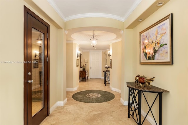 hallway with ornamental molding and light tile patterned flooring