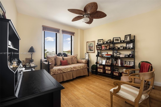 sitting room with ceiling fan and light wood-type flooring