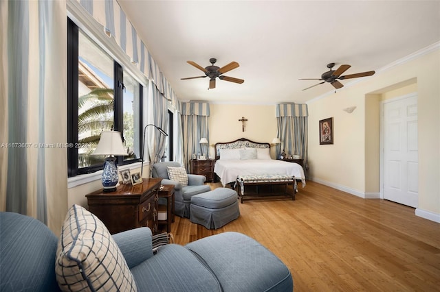 bedroom featuring ornamental molding, hardwood / wood-style floors, and ceiling fan