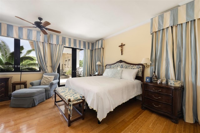 bedroom featuring light hardwood / wood-style floors, ornamental molding, and ceiling fan