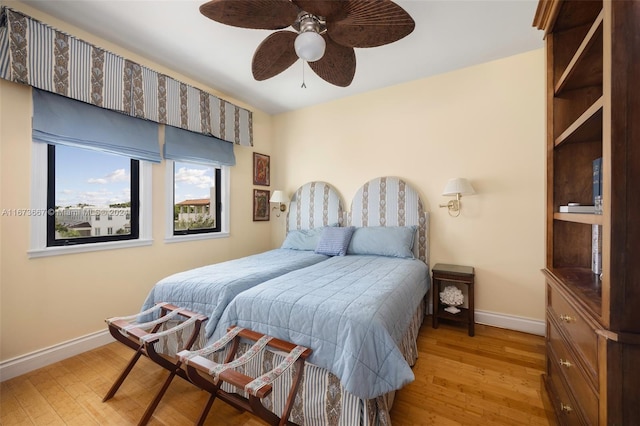 bedroom with light hardwood / wood-style flooring and ceiling fan