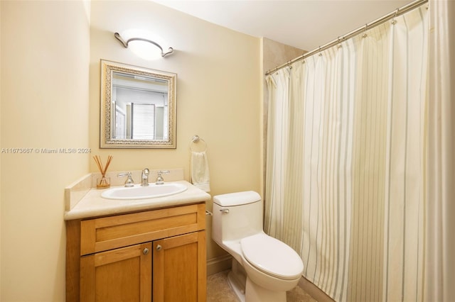 bathroom featuring vanity, curtained shower, and toilet