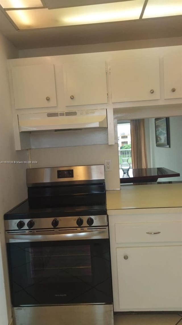 kitchen with white cabinetry and stainless steel range oven