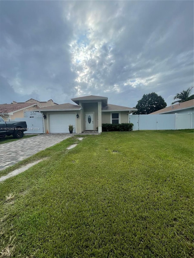 view of front of property with a front lawn and a garage