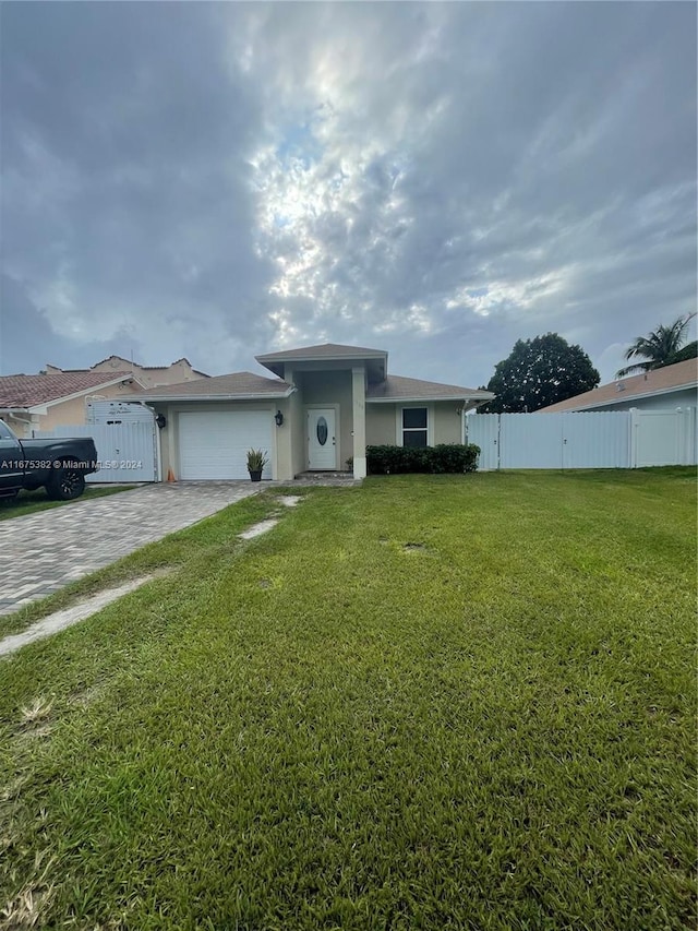 1369 Rainbow Ave, Palm Beach, FL 33406 - view of front facade with decorative driveway, stucco siding, and a garage