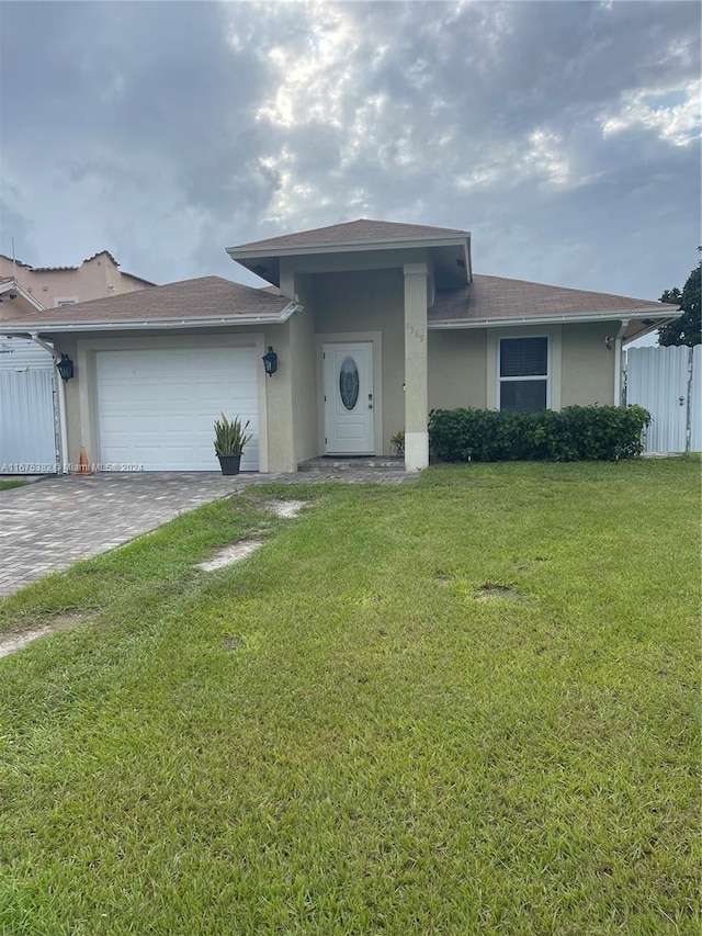 view of front facade with a front yard and a garage