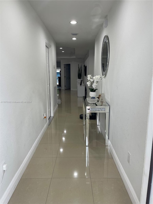 hall with light tile patterned floors