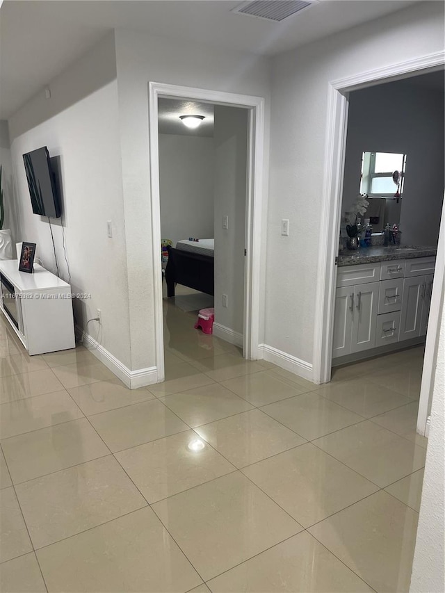 1369 Rainbow Ave, Palm Beach, FL 33406 - hallway with light tile patterned floors and baseboards
