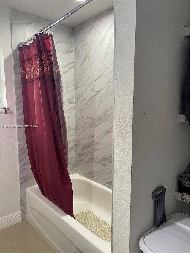 bathroom with shower / tub combo with curtain and tile patterned floors