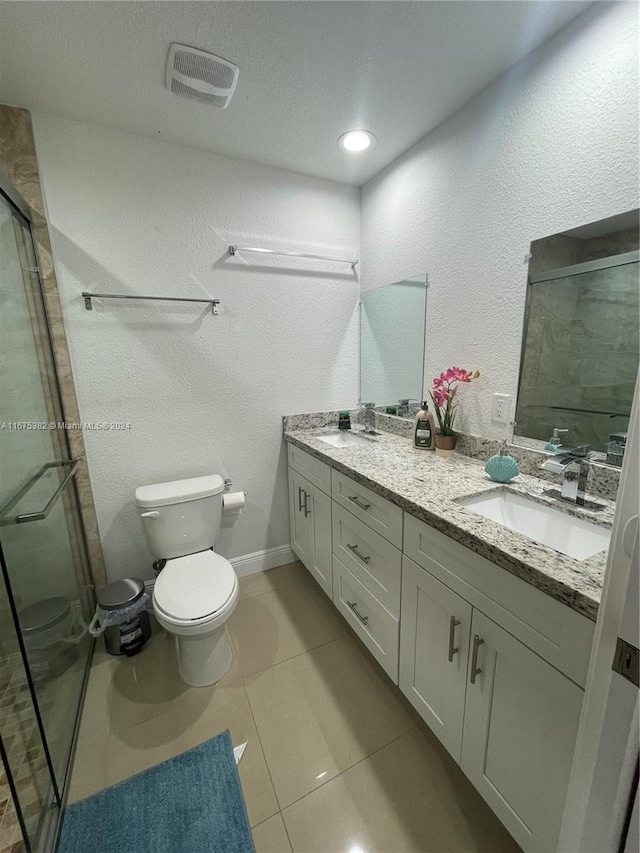 bathroom with toilet, an enclosed shower, vanity, and tile patterned flooring