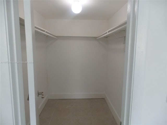 walk in closet featuring light tile patterned floors