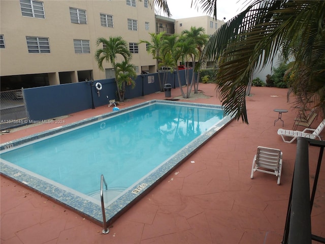 view of swimming pool with a patio area