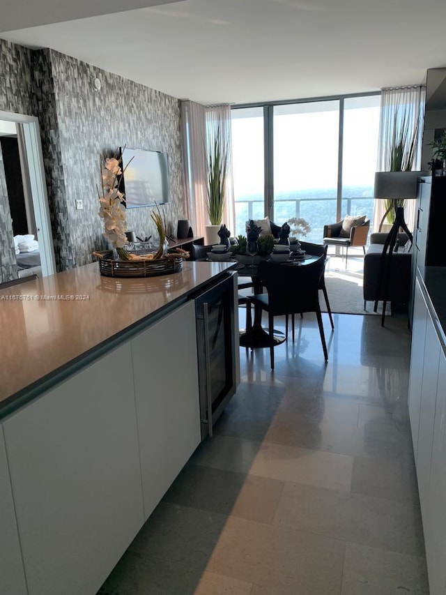 kitchen featuring white cabinetry and beverage cooler