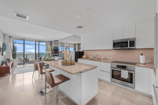 88 SW 7th St Unit 3806, Miami, FL 33130 - kitchen with beverage cooler, modern cabinets, and white cabinets