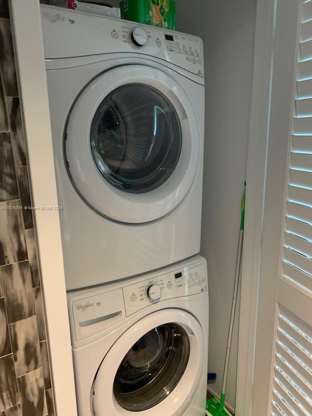 washroom featuring stacked washer and clothes dryer