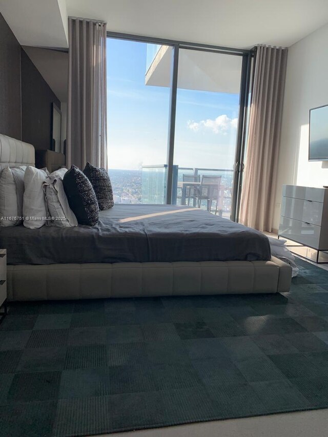 88 SW 7th St Unit 3806, Miami, FL 33130 - bedroom featuring a wall of windows and dark colored carpet