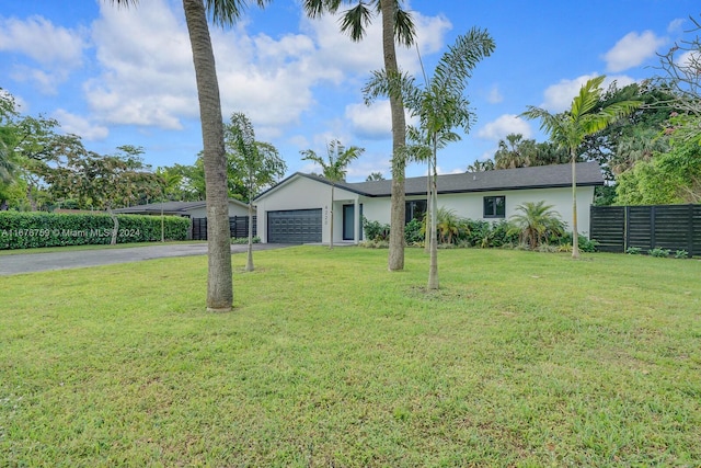 ranch-style house with a garage and a front lawn