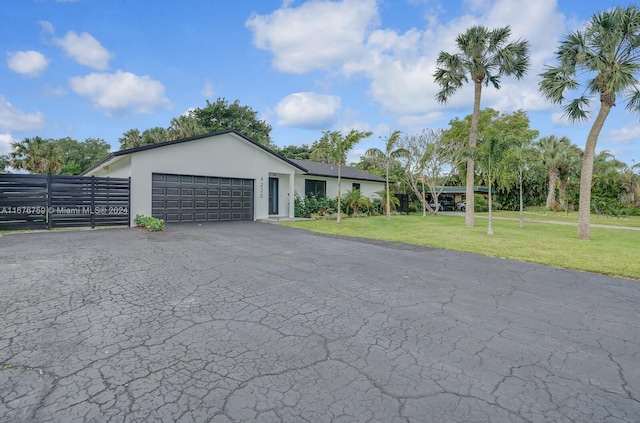 view of front of home with a front lawn and a garage