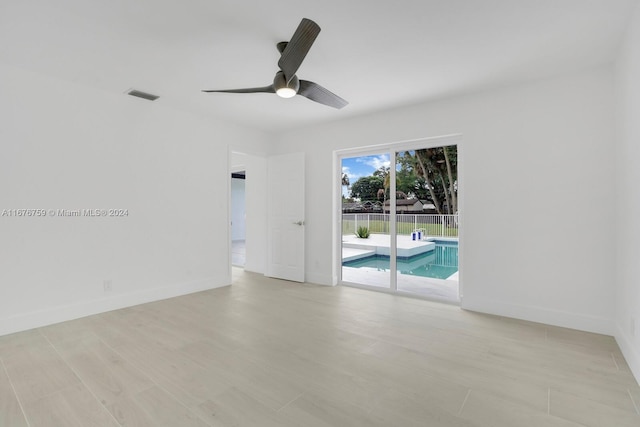 unfurnished room featuring light hardwood / wood-style flooring and ceiling fan