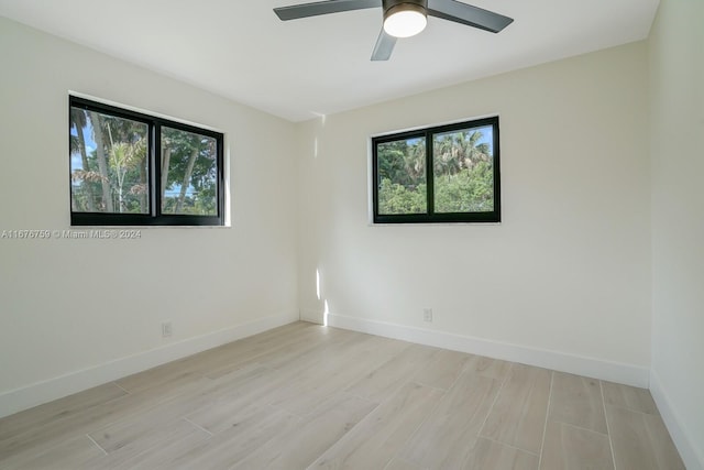 unfurnished room featuring light wood-type flooring and ceiling fan