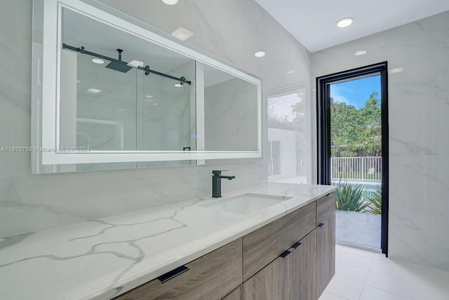 bathroom with vanity, tile patterned floors, and a shower