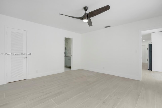 spare room featuring ceiling fan and light hardwood / wood-style flooring