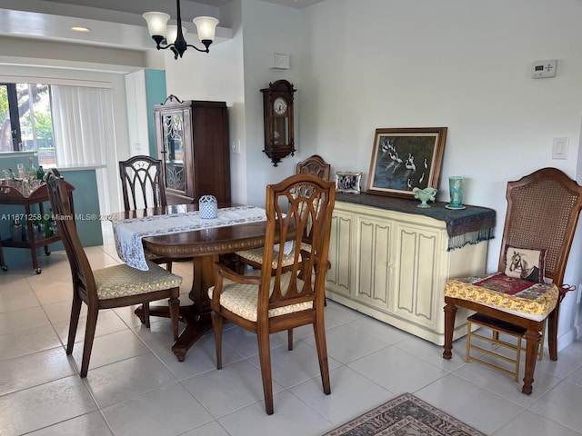 tiled dining space featuring an inviting chandelier