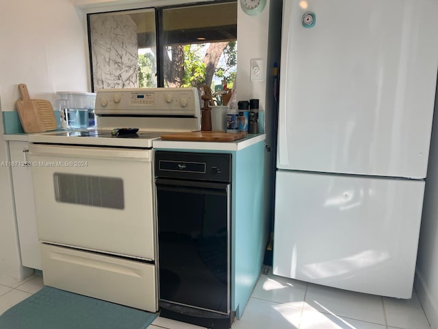 kitchen with light tile patterned flooring and white appliances