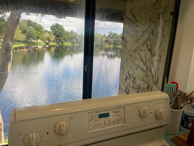 interior space featuring washer / dryer and a water view