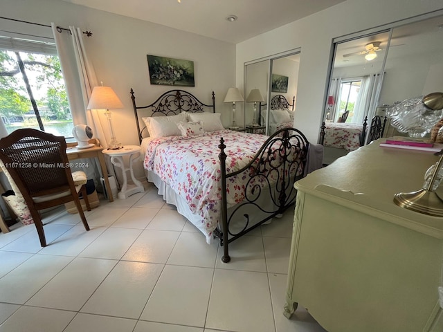 bedroom featuring multiple windows, a closet, and light tile patterned flooring