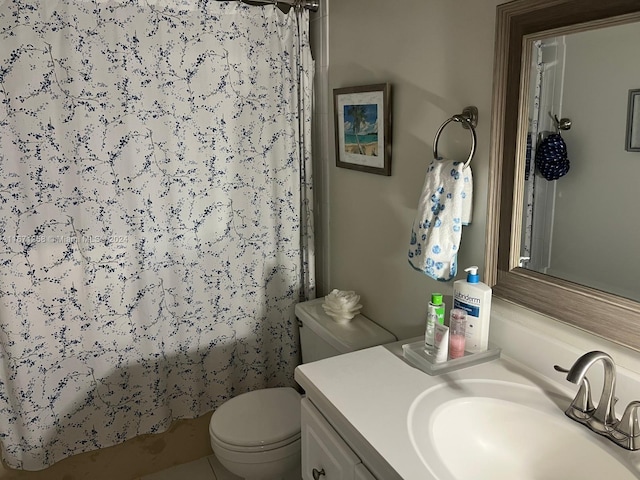 bathroom featuring toilet, vanity, and tile patterned floors