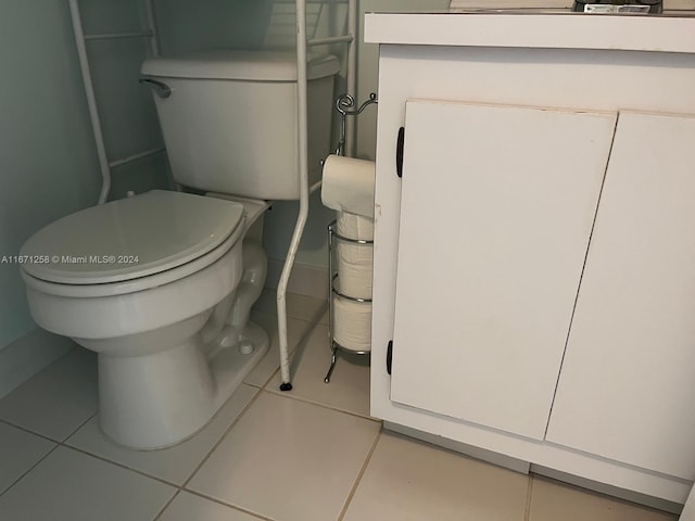 bathroom with toilet and tile patterned flooring