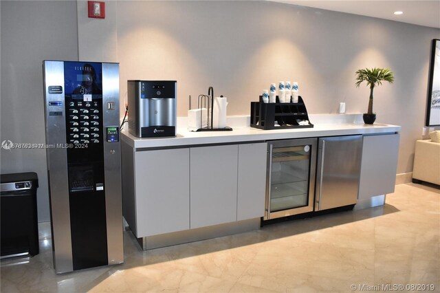 kitchen featuring white cabinetry and beverage cooler