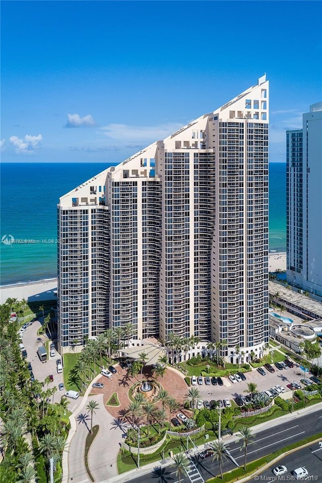 view of building exterior with a view of the beach and a water view