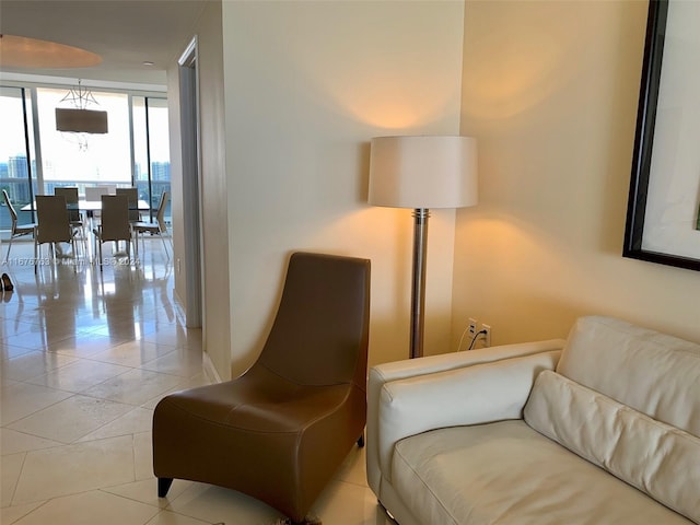 living area featuring expansive windows and light tile patterned floors